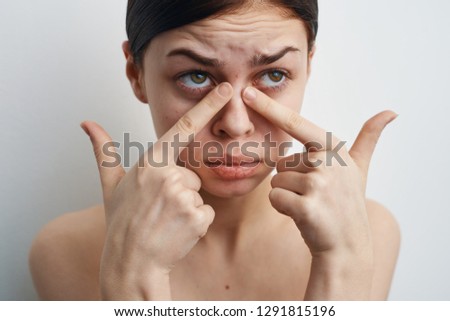 sad woman squeezes acne on the nose skin problem