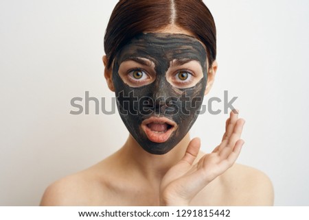 surprised woman in a cosmetic mask portrait