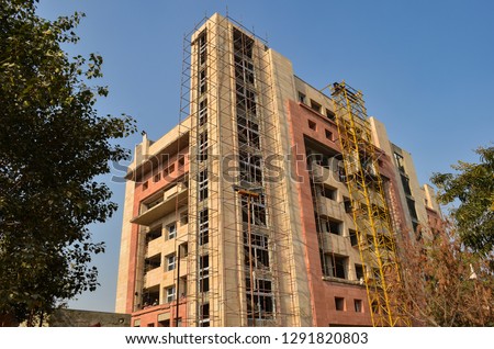 Under construction high rise office complex against skyline of Gurgaon, Noida, Mumbai, New Delhi NCR. These modern housing cum office real estate projects boast modern architecture