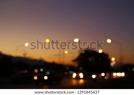 night light of traffic car in the urban street with beautiful twilight sunset sky, abstract blur bokeh background
