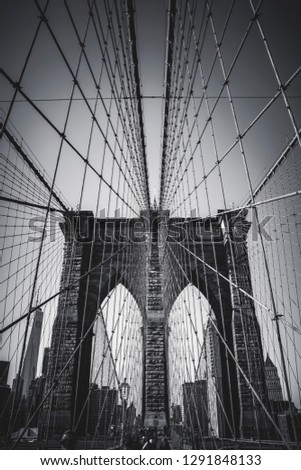 Vertical view of the classic Brooklyn bridge in black and white. NYC