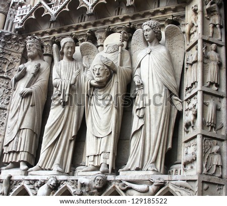 St. Denis Decapitated seen at the left hand side of the main entrance to Notre Dame Cathedral.