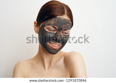 woman smiling in a cosmetic clay mask portrait