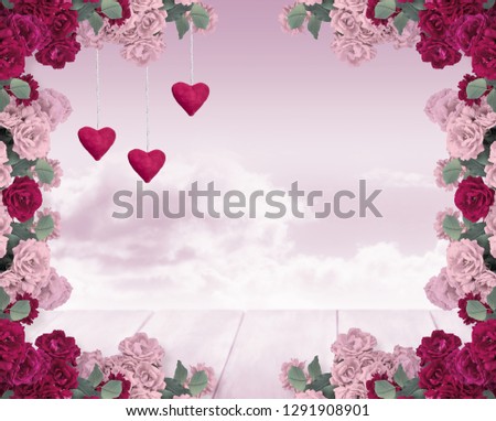 Roses frame composition, velvet hears and wooden table or stage on background of mysterious sky and clouds and place for your text or decoration