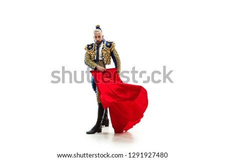 Torero in blue and gold suit or typical spanish bullfighter isolated over white studio background. The taming, achieving the goal, mortification, conquest, boss, leadership, battle, win, winner Royalty-Free Stock Photo #1291927480