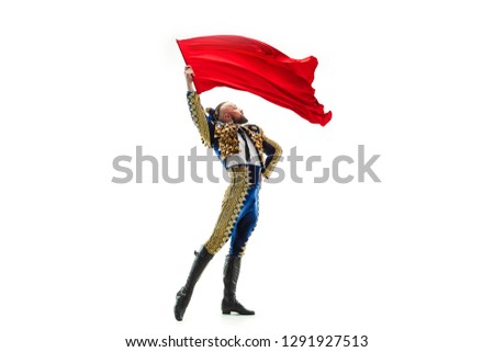Torero in blue and gold suit or typical spanish bullfighter isolated over white studio background. The taming, achieving the goal, mortification, conquest, boss, leadership, battle, win, winner Royalty-Free Stock Photo #1291927513