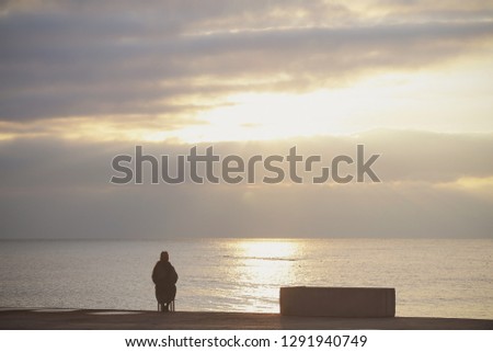 girl alone sitting on a chair in a deserted place