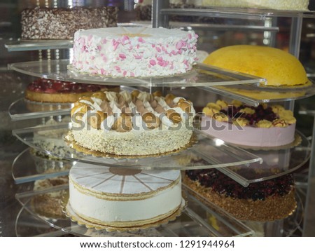 Several Types of Stuffed Cakes inside a Pastry Display Stand.