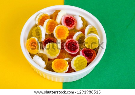 Sweet colored jelly candies on white plate. Studio Photo