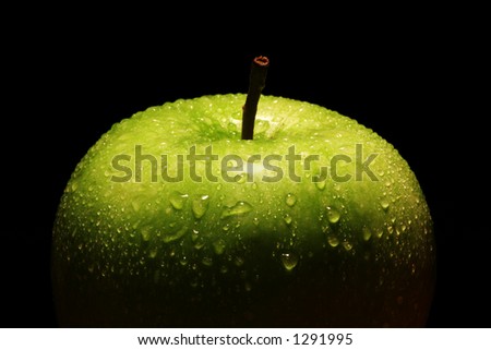Single green apple on black background. Royalty-Free Stock Photo #1291995