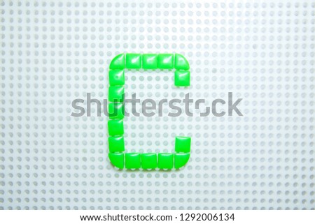 letter C created with children toys similar to pixels