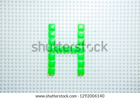 letter H created with children toys similar to pixels