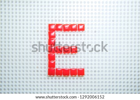 letter E created with children toys similar to pixels