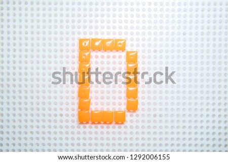 letter D created with children toys similar to pixels
