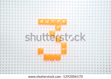 number 3 created with children toys similar to pixels