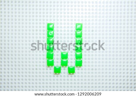 letter W created with children toys similar to pixels
