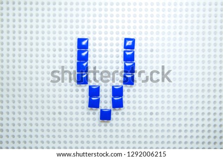 letter V created with children toys similar to pixels