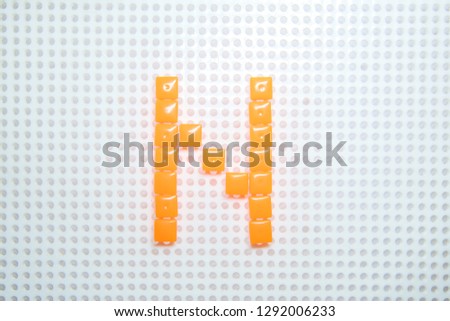 letter N created with children toys similar to pixels
