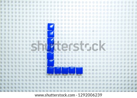 letter L created with children toys similar to pixels
