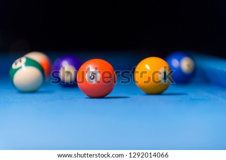 Billiard balls in a blue pool table
