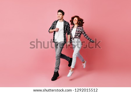 Full length shot of caucasian couple isolated on pink. Man in casual attire chilling with girlfriend.