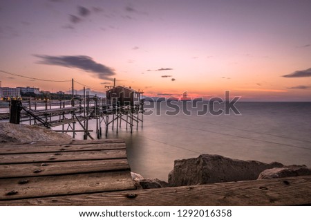 Beautiful seascape with a view of a trabucco at sunset