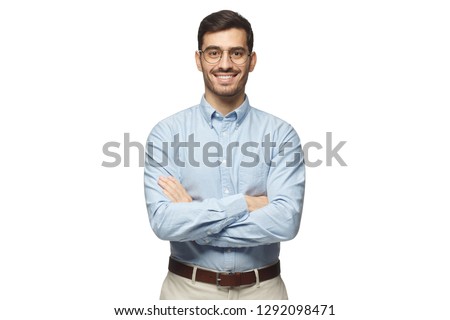 Successful young businessman standing with crossed arms isolated on white background