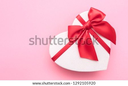Love Valentine's Day. Love background. Gifts in the form of hearts on a pink background with the inscription love. Copy space for text. The concept of romance and love. 
