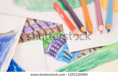 coloring pencils of all colours, on the drawings of a child, sharpened with wooden scabs