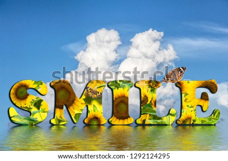 The Word Smile Filled with Sunflowers Reflected in Water and Against a Blue Cloud Filled Sky
