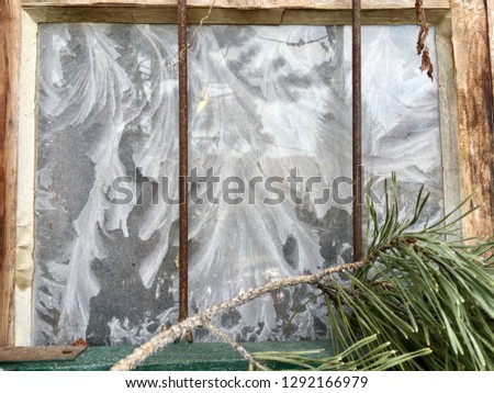 frost tracery covering an old, rustic window/masterpiece of nature, ice flowers on glass/untransparent pane, beautiful frozen water in cold winter time
