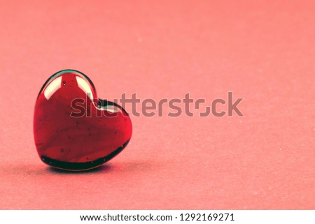 Stylish red heart as a symbol of love and Valentines day on coral background