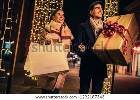 Lovely young couple at Christmas shopping