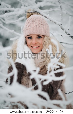 Photo of blonde woman on walk in winter forest