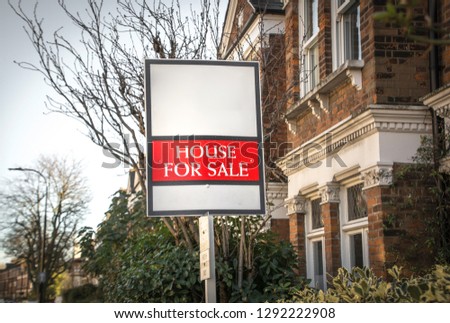 House For Sale sign on suburban residential street