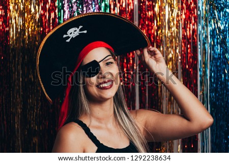 Beautiful young woman having fun with a fake party pirate costume