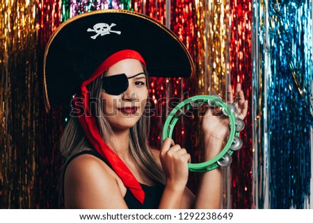 Beautiful young woman having fun with a fake party pirate costume. Brazilian Carnival concept