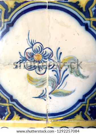 A fragment of a traditional Portuguese tile azulezhu with a picture of a flower