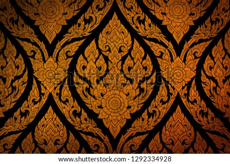 Closeup Thai pattern carving lotus picture at door in temple
