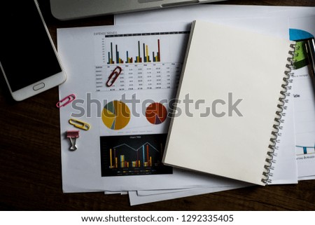 Close up office desk table with laptop, note book, mobile coffee and pen. Selective focus. Business concept. Copy space. 