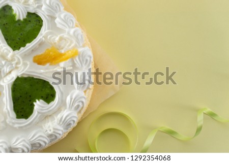 white cake on a colored background with ribbons shot from above