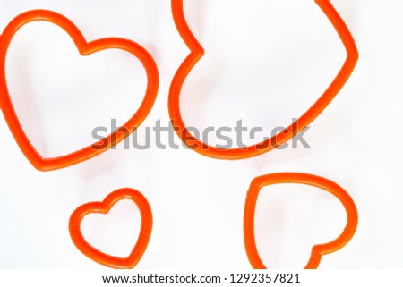 Close up top view of heart shape cookie cutters isolated on a white background.