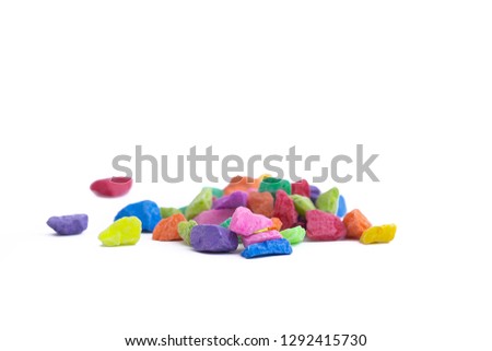 multi color pebbles for decoration on white background
