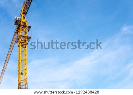 Construction industry of Engineer Business, Technology Concept with Industrial yellow cranes with blue sky ,clouds background on site building from high ground and heavy material.       