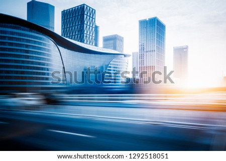 blurred empty urban road and modern buildings at a sunny day