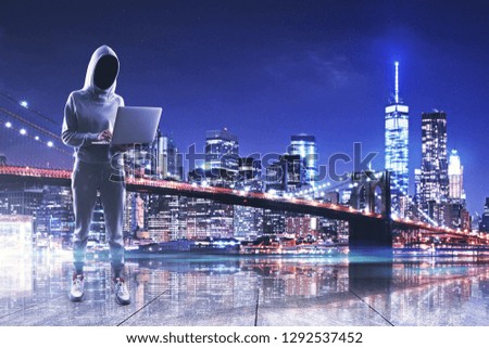 Hacker with laptop on night city background. Attack and virus concept. Double exposure 