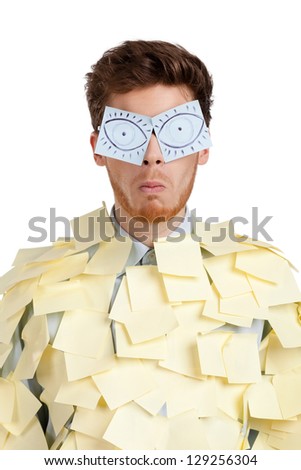 Young man with eyes painted on stickers, covered with yellow sticky notes