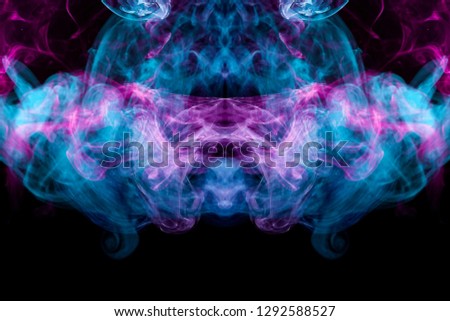 Thick colorful bkue and pink smoke  in the form of a butterfly on a black isolated background. Background from the smoke of vape. Mocap for cool t-shirts
