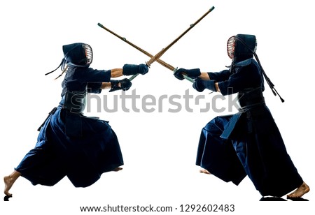 two Kendo martial arts fighters combat fighting in silhouette isolated on white bacground Royalty-Free Stock Photo #1292602483
