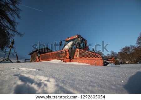 Old snowcat in deep powder snow